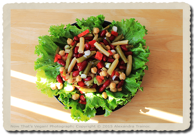 A tasty combination of beans on a bed of lettuce.