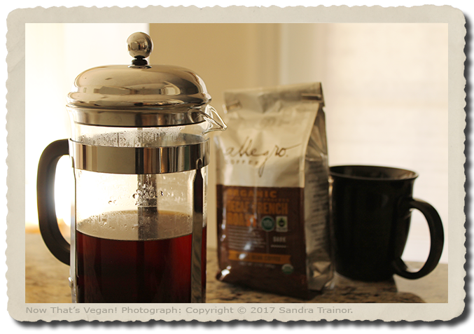 A coarsely ground, organic, dark French roast, Swiss Water Processed (SWP) decaf coffee made using a French press.
