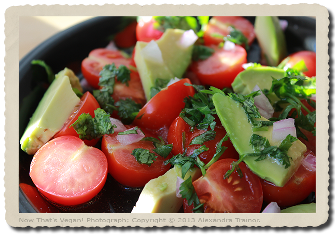 A salad made with tomatos and avocados.