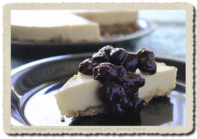 A vegan cheesecake topped with blueberries.